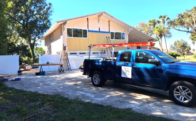 Three C's Roofing Truck by siding house