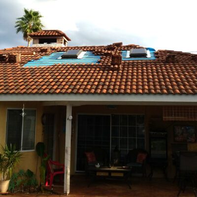 Two skylights being repaired on tile roofing