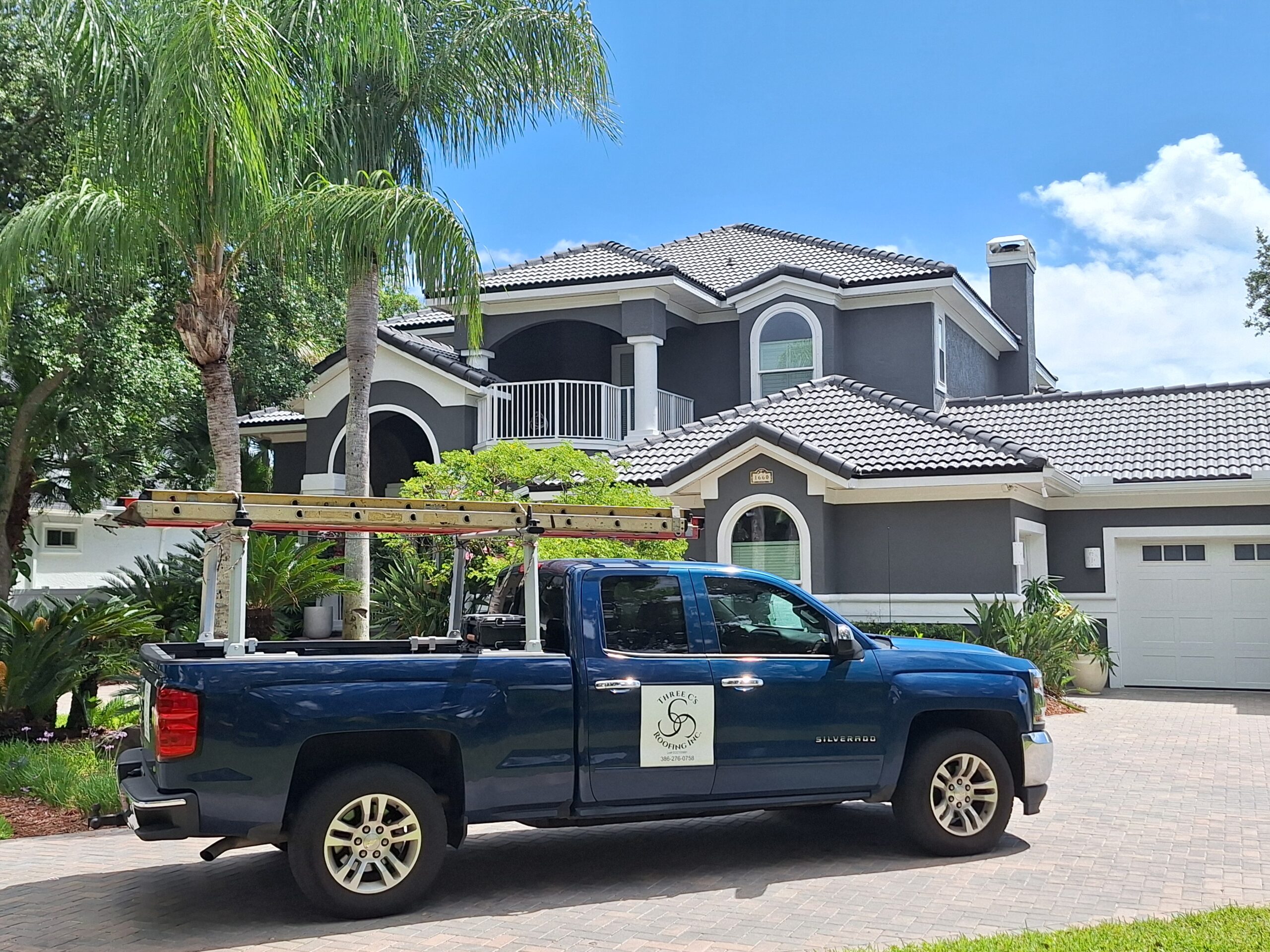 Three C's Roofing truck in front of Tile Roof home